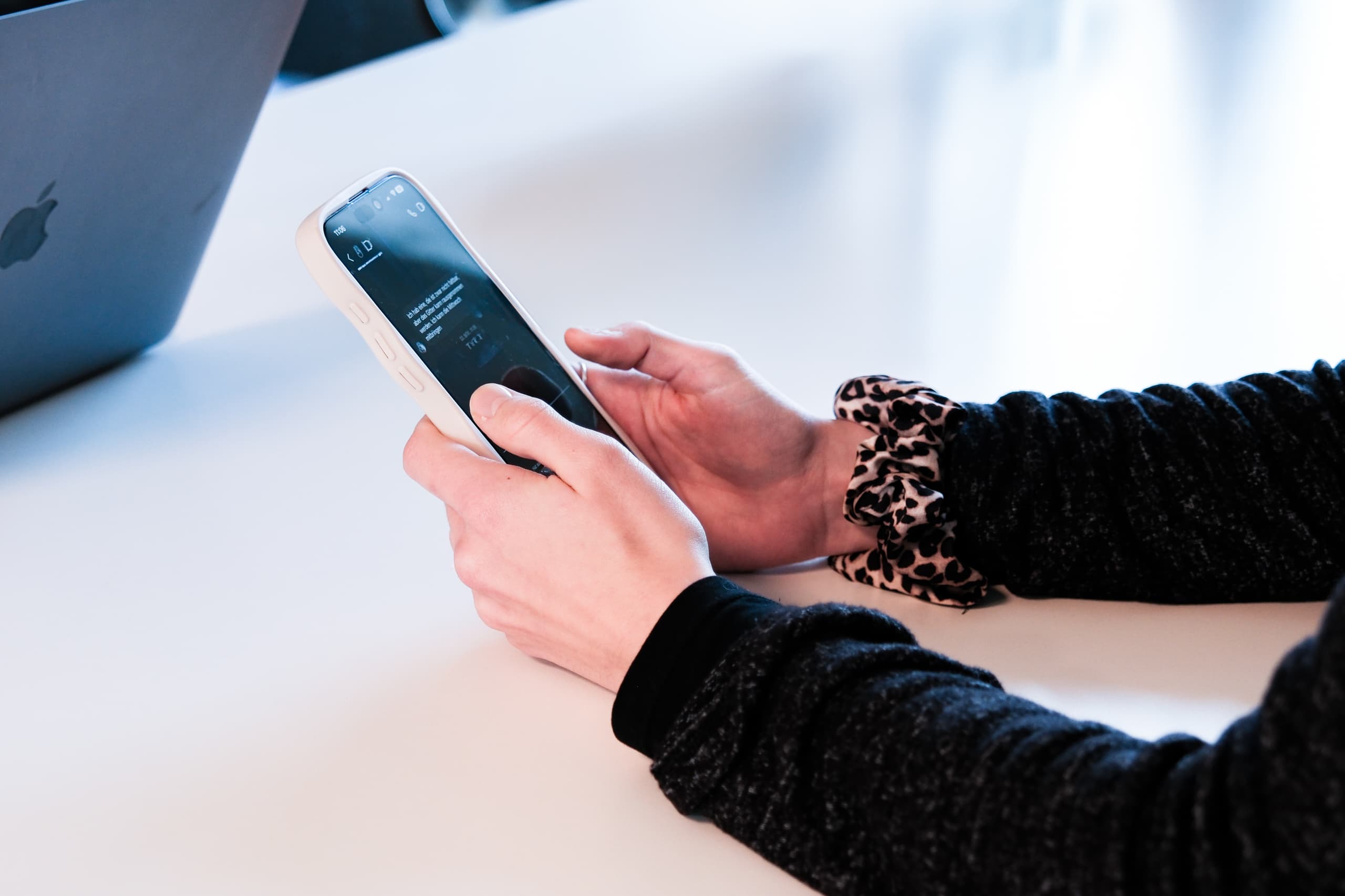 Hand bedient Smartphone mit Chatbot-Oberfläche