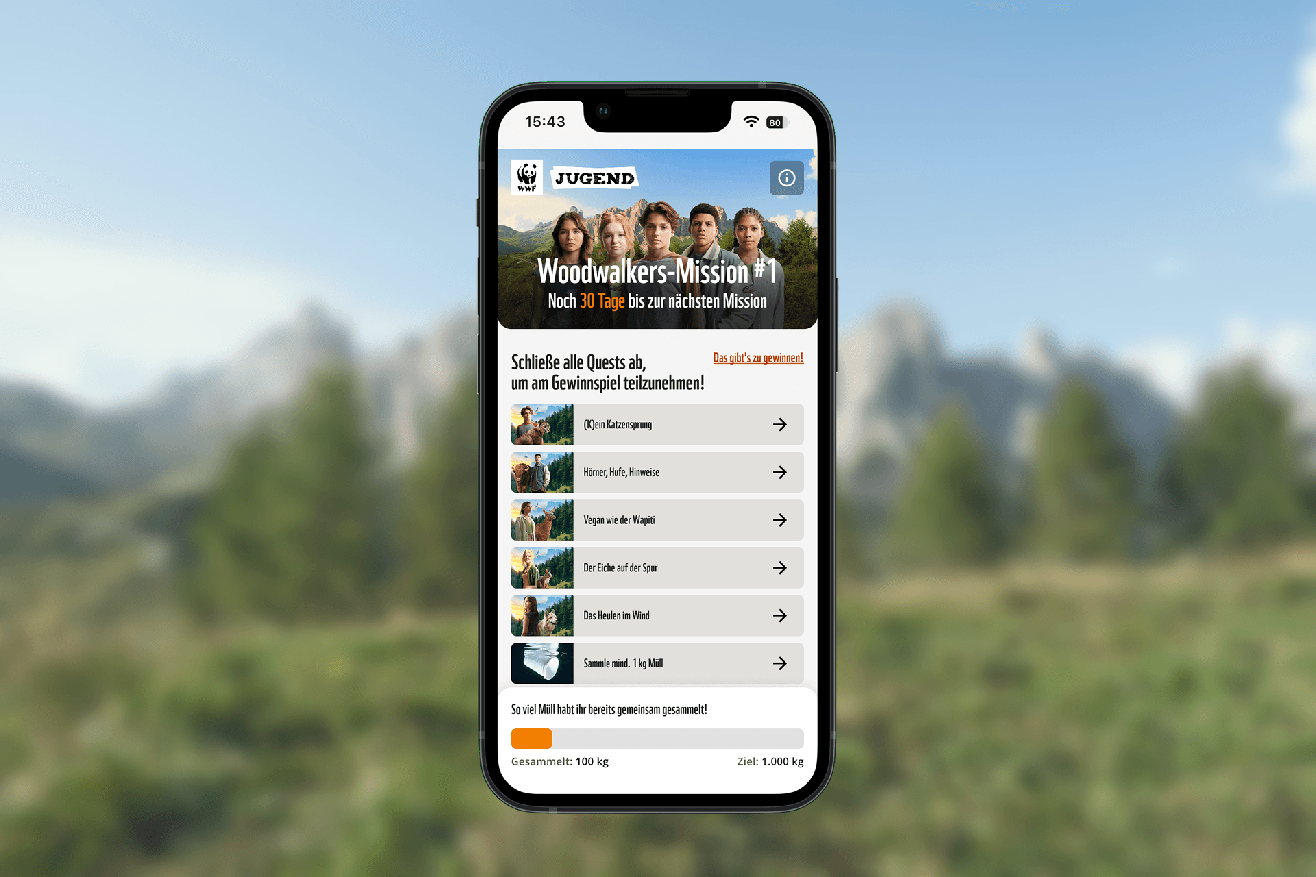 PandAktiv-App-Screen mit Woodwalkers-Mission 1: Questliste und Fortschrittsanzeige vor Bergpanorama-Hintergrund