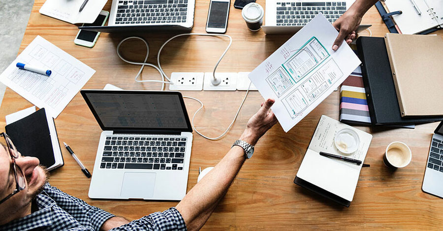 Meeting UI Design on table with wireframes