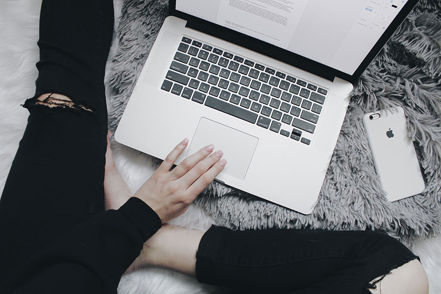 Woman in jeans in front of laptop