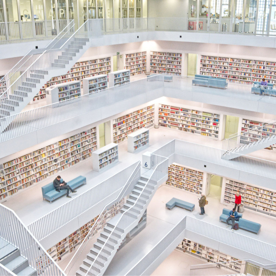 Bibliothek mit Büchern und weißen Treppen